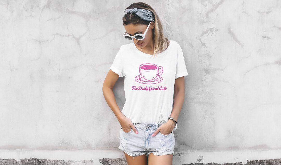 custom promotional apparel for telling a brand story. A girl wearing a shirt that says "The Daily Grind Cafe"